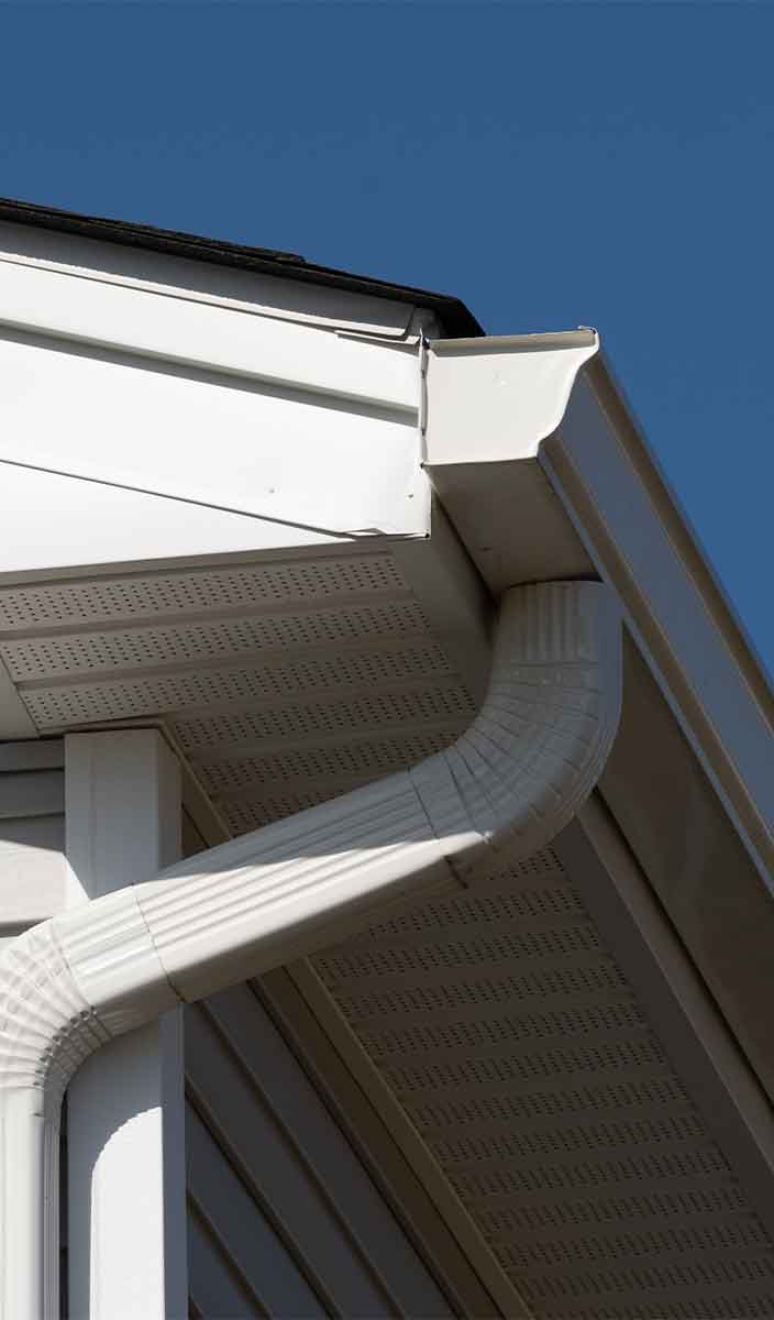 Larger seamless gutters and downspouts installed on a New Jersey home to prevent future overflow